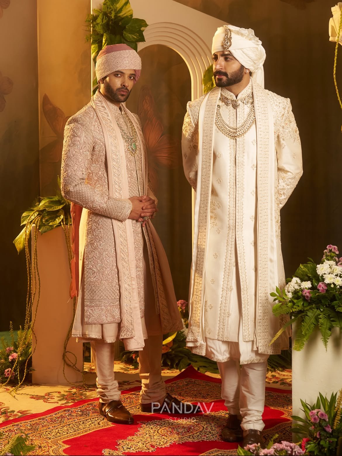 Two grooms in rose and ivory wedding sherwanis